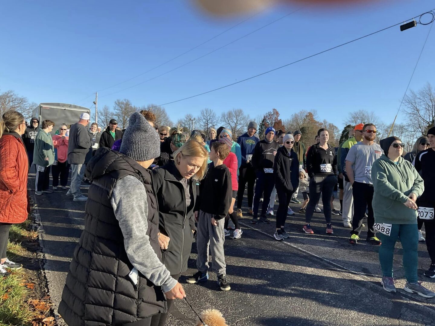 A group of people standing around in the street.